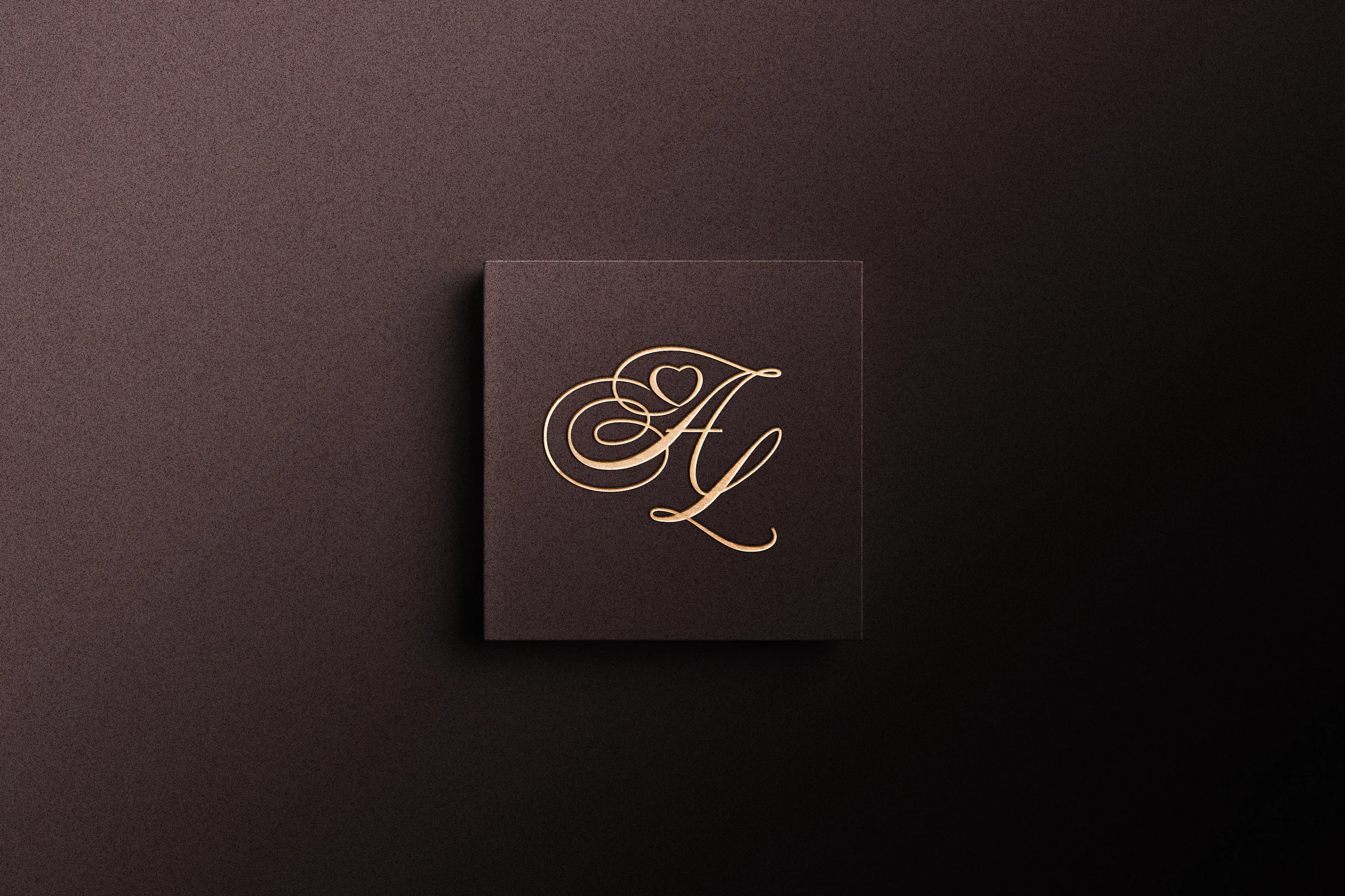 The A–L monogram in gold on chocolate-brown stationery.