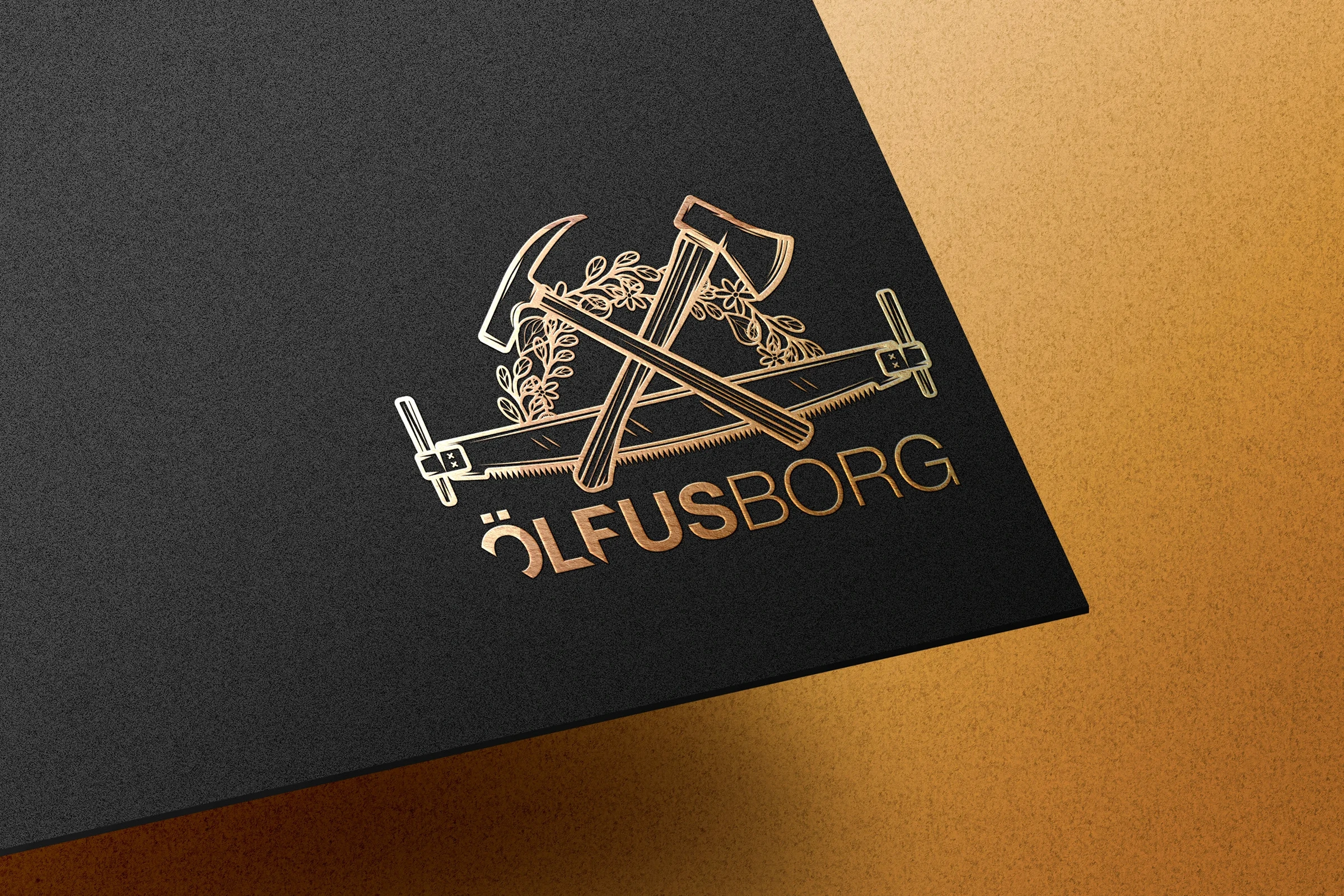 Ölfusborg illustrated construction emblem in gold on a black presentation card
